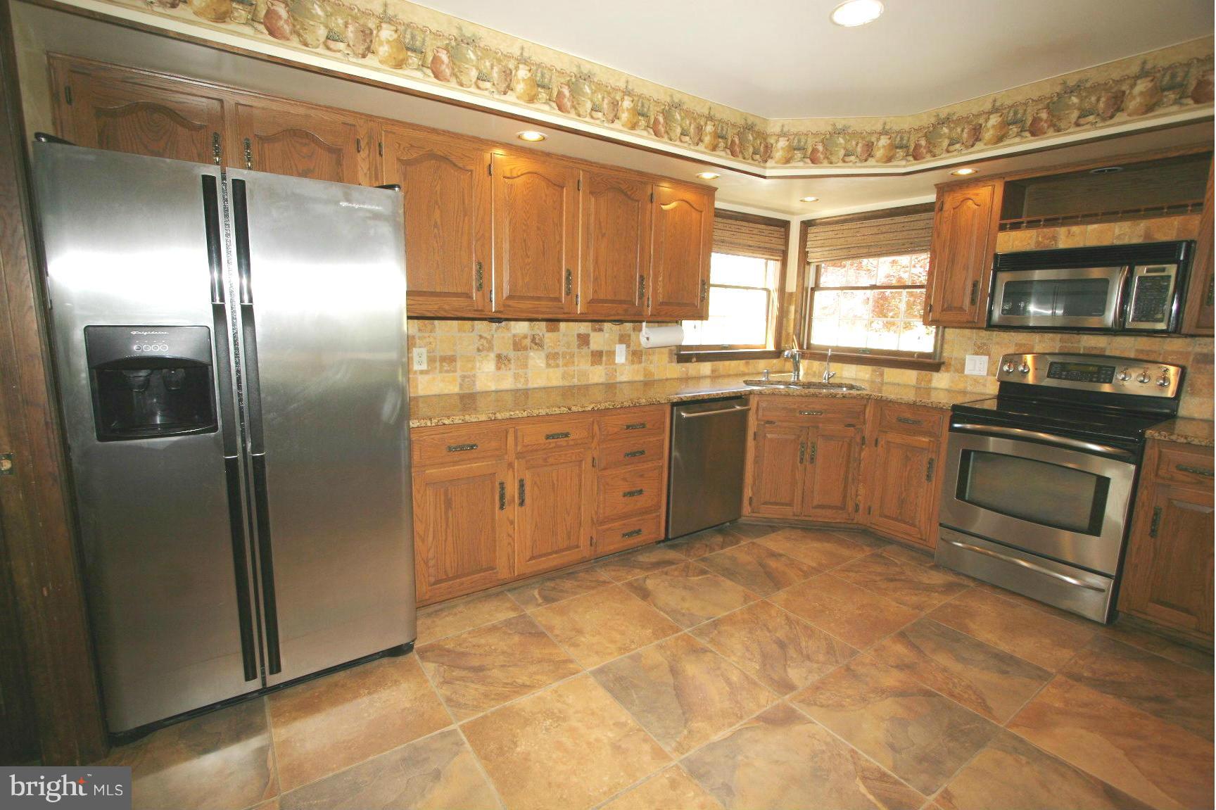 20834 Netz Road Boonsboro, MD 21713 - Photo 3 of 30 a kitchen with stainless steel appliances granite countertop a refrigerator a stove and a sink