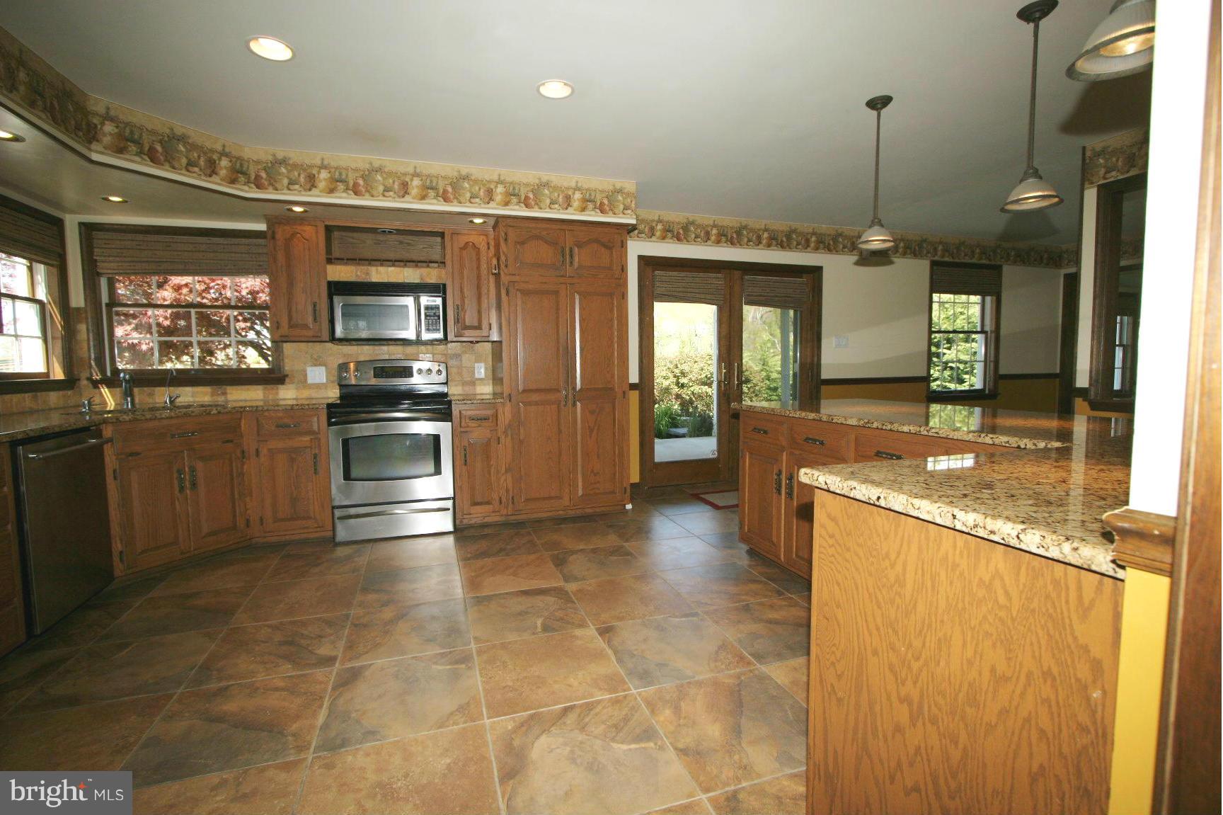 20834 Netz Road Boonsboro, MD 21713 - Photo 4 of 30 a kitchen with stainless steel appliances granite countertop a sink and a refrigerator