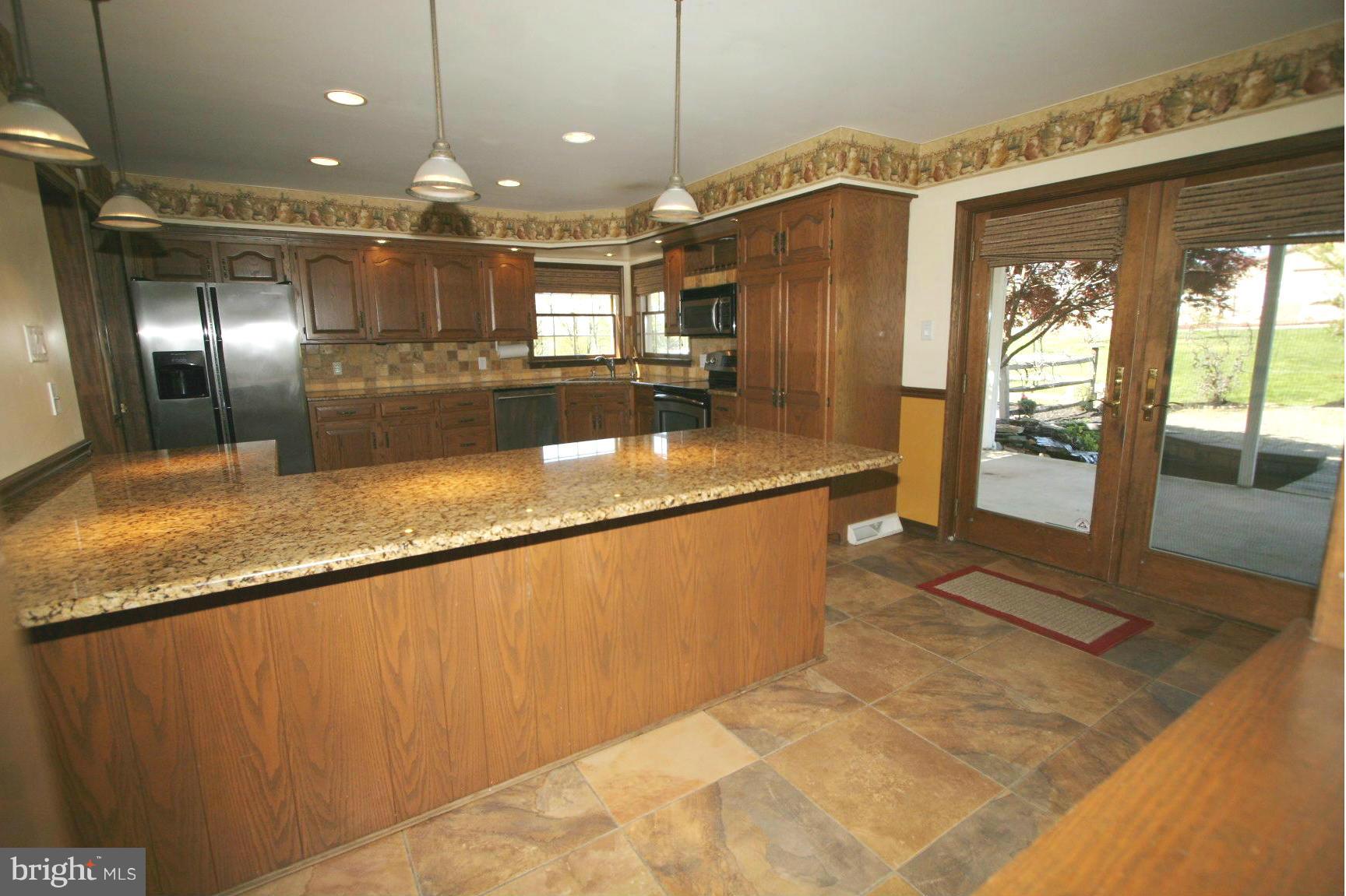 20834 Netz Road Boonsboro, MD 21713 - Photo 8 of 30 a large kitchen with granite countertop a large counter top and stainless steel appliances