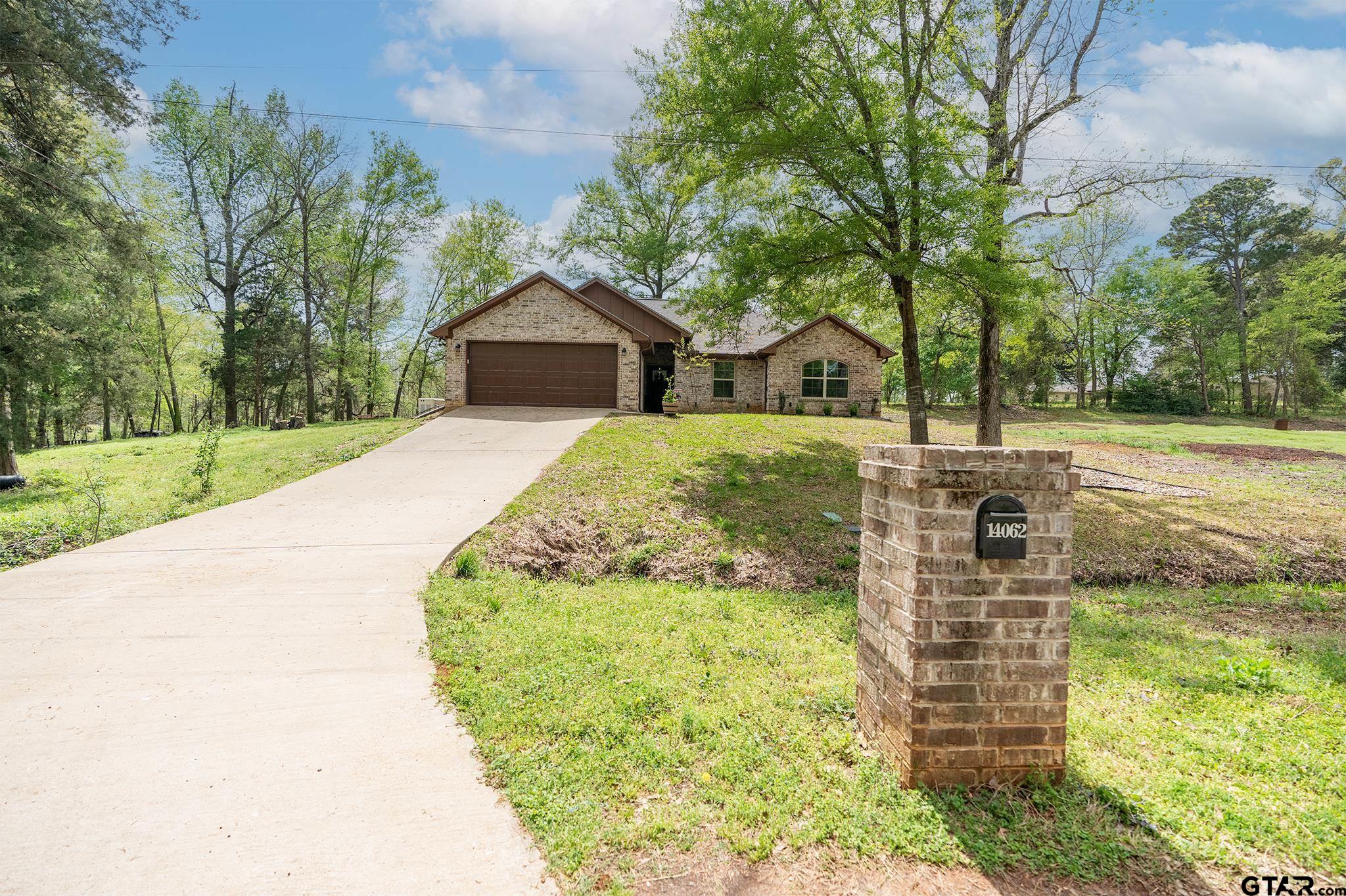 14062 Bent Trail Tyler, TX 75707 - Photo 1 of 46 a front view of a house with a garden