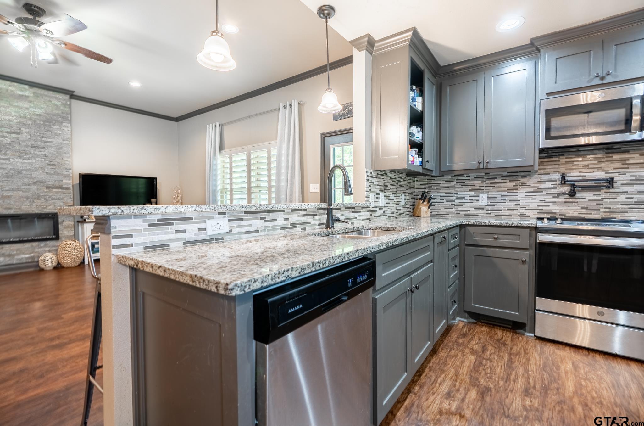 14062 Bent Trail Tyler, TX 75707 - Photo 10 of 46 a kitchen with a sink stove and microwave