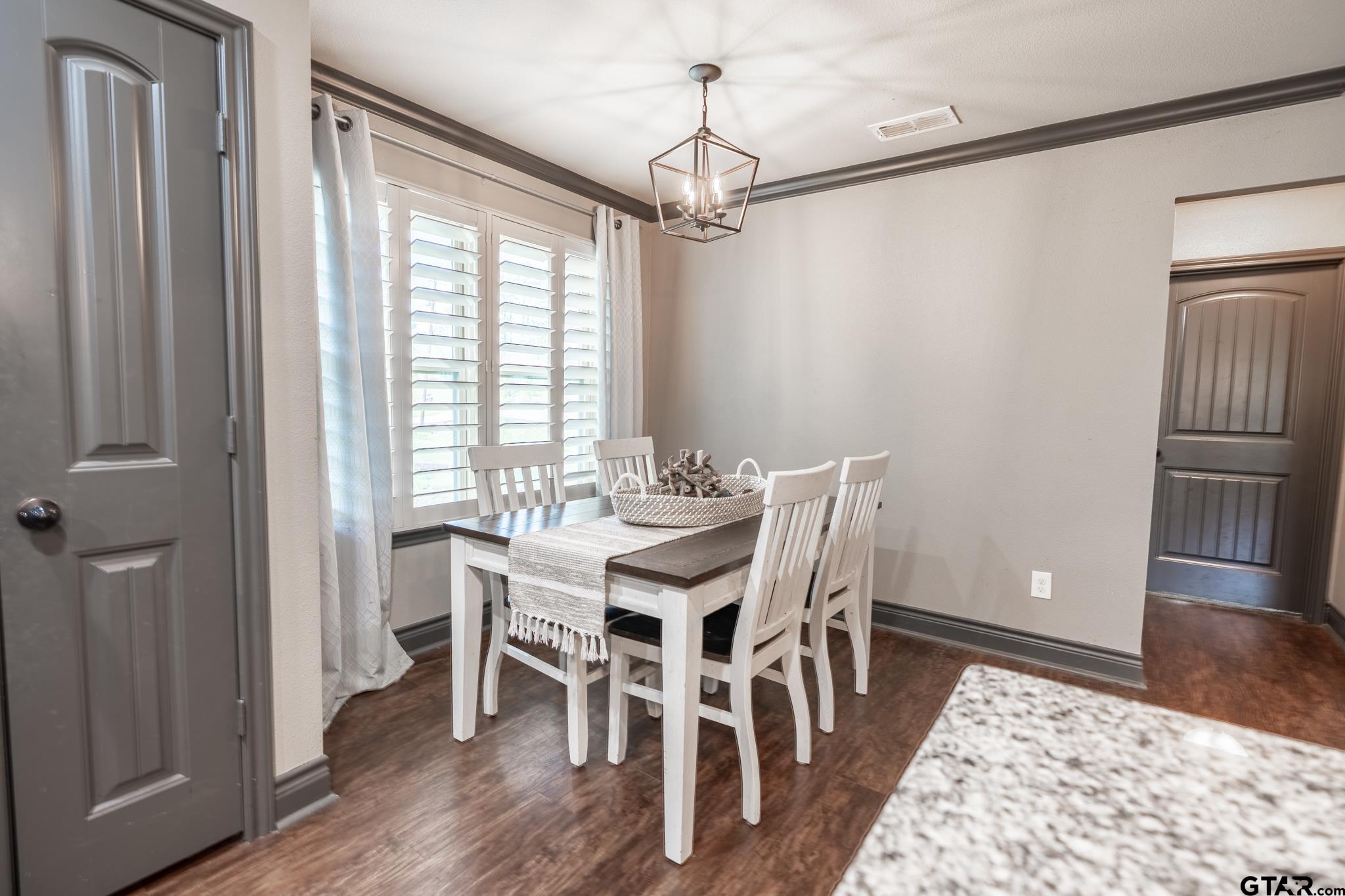 14062 Bent Trail Tyler, TX 75707 - Photo 12 of 46 a view of a dining room with furniture window and wooden floor