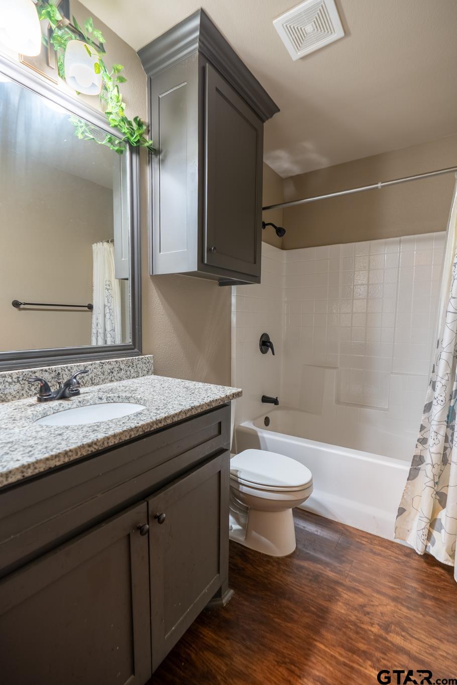 14062 Bent Trail Tyler, TX 75707 - Photo 15 of 46 a bathroom with a granite countertop sink toilet a large mirror and shower