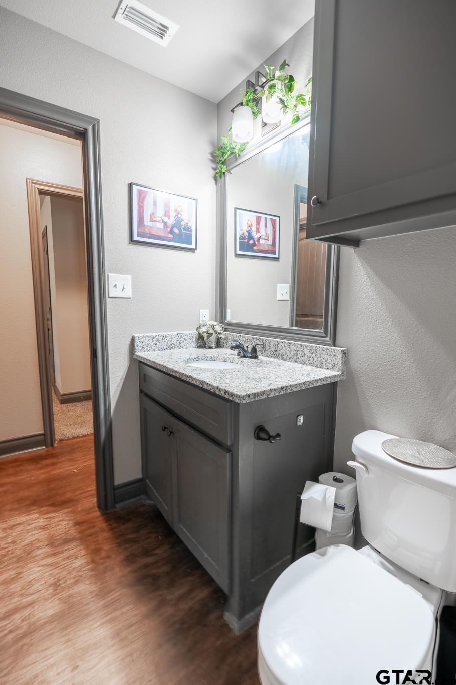 14062 Bent Trail Tyler, TX 75707 - Photo 17 of 46 a bathroom with a toilet sink and mirror