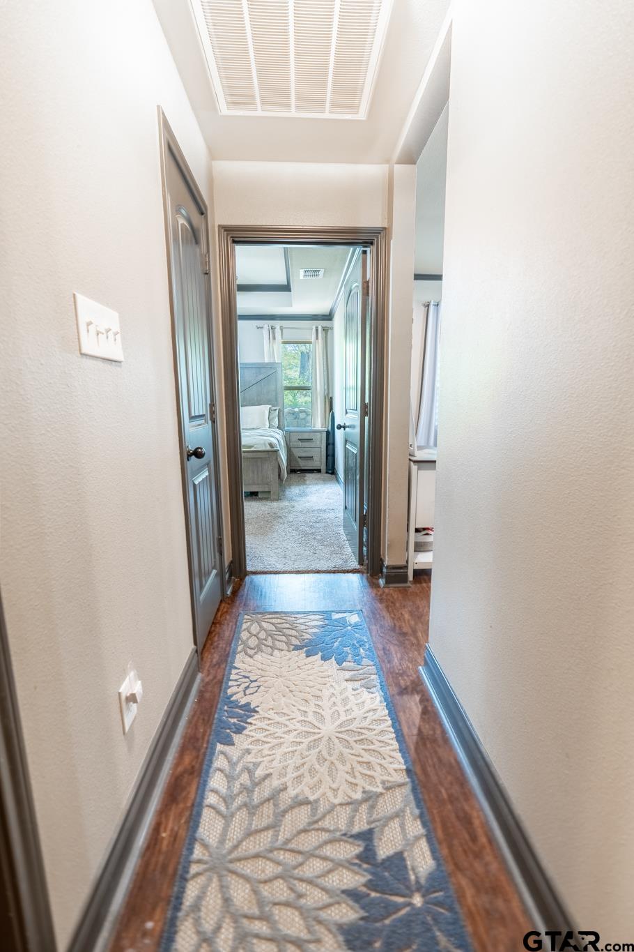 14062 Bent Trail Tyler, TX 75707 - Photo 24 of 46 a view of a hallway with wooden floor and a living room