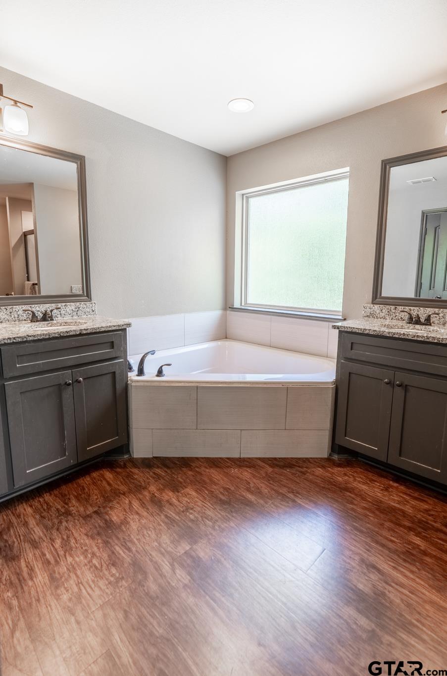 14062 Bent Trail Tyler, TX 75707 - Photo 29 of 46 a spacious bathroom with a bathtub and a sink
