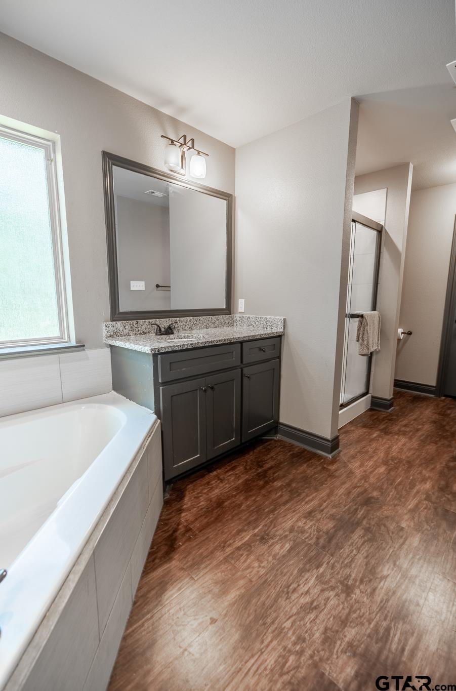 14062 Bent Trail Tyler, TX 75707 - Photo 30 of 46 a spacious bathroom with a tub sink and mirror