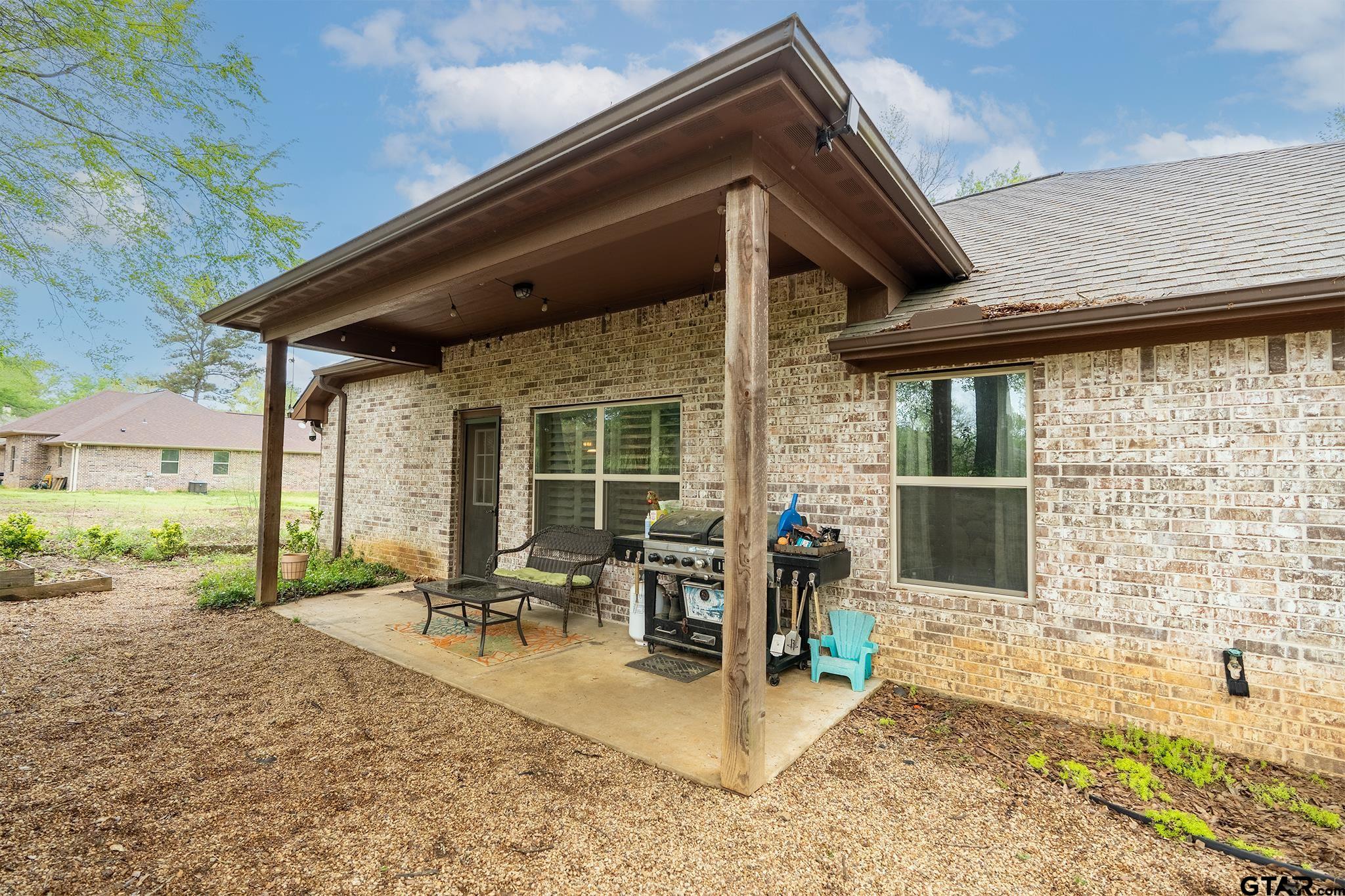14062 Bent Trail Tyler, TX 75707 - Photo 33 of 46 a view of a patio with table and chairs wooden floor and fence