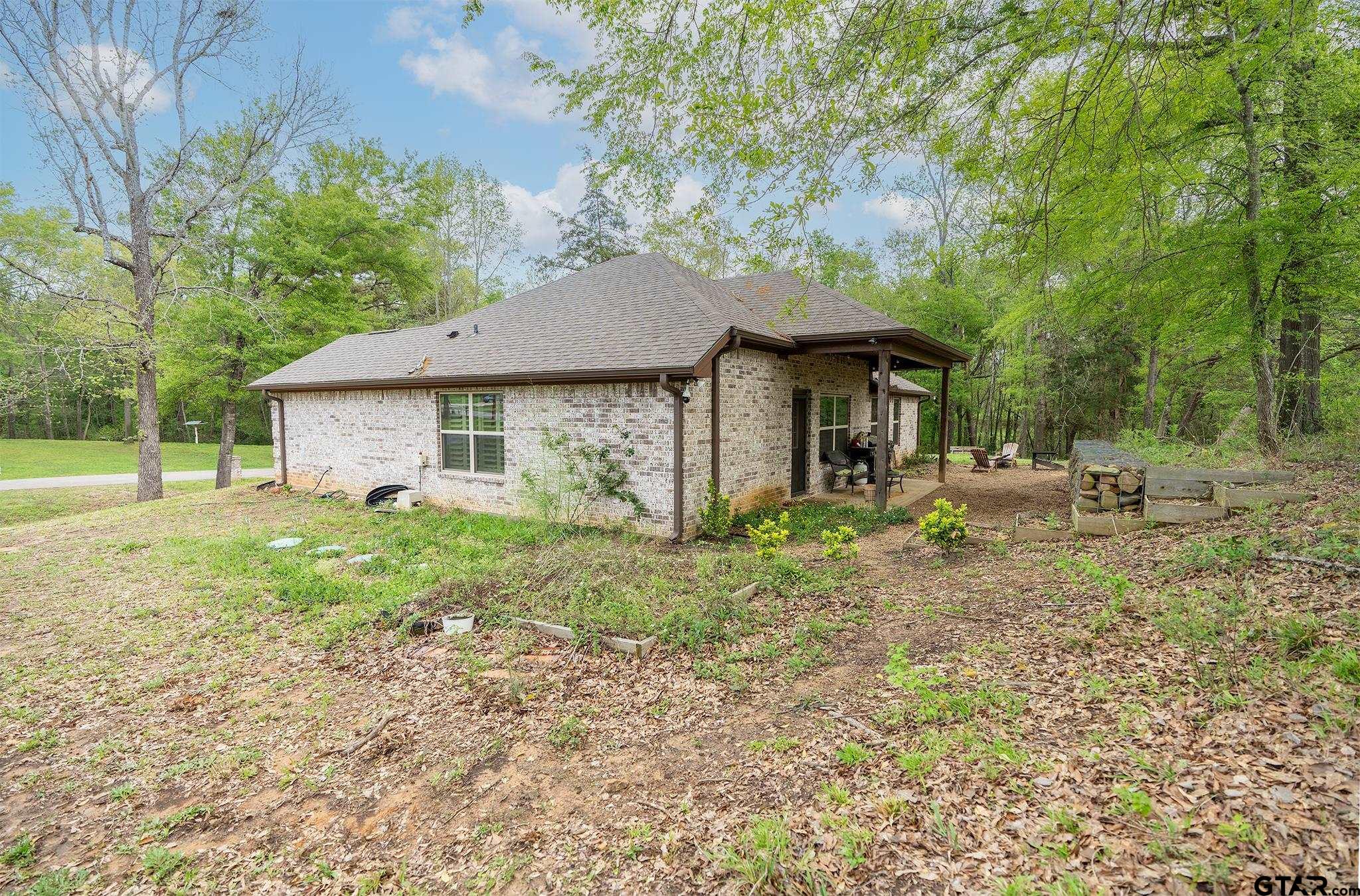 14062 Bent Trail Tyler, TX 75707 - Photo 35 of 46 a front view of a house with garden