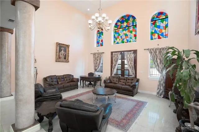 a spacious bedroom with a bed and a flat screen television