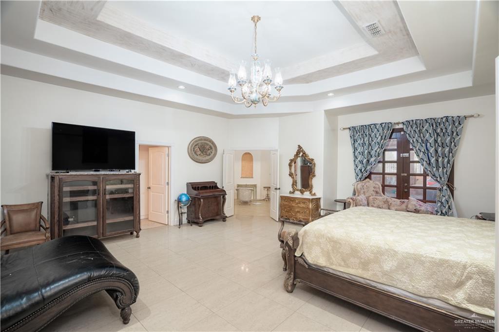 508 El Paisano Road Rio Grande City, TX 78582 - Photo 15 of 40 a spacious bedroom with a bed and a flat screen television
