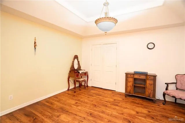 a spacious bedroom with a bed and a tv on table