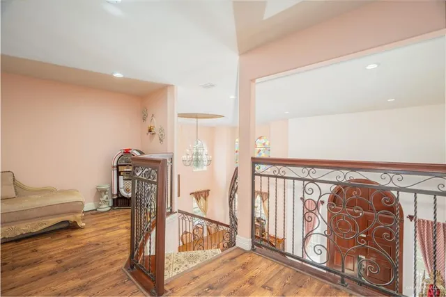 a kitchen with stainless steel appliances granite countertop a stove top oven a sink dishwasher a dining table and chairs with wooden floor