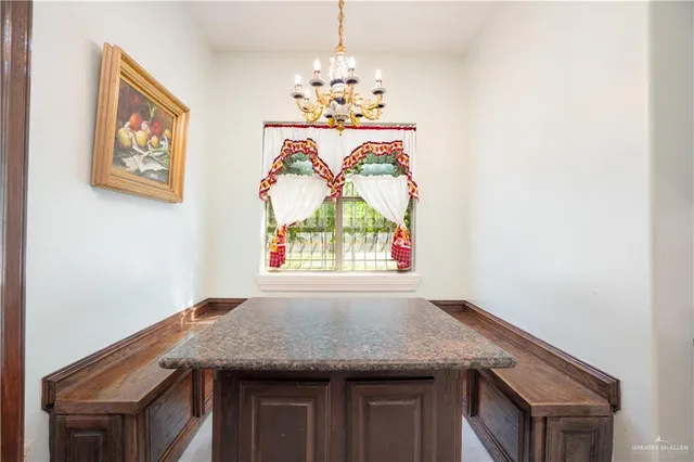 a spacious bedroom with a bed and a chandelier