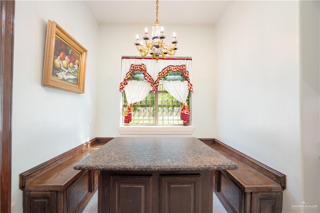 508 El Paisano Road Rio Grande City, TX 78582 - Photo 30 of 40 a kitchen with a table and a chandelier