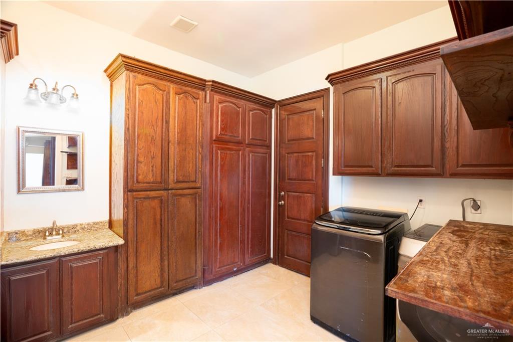 508 El Paisano Road Rio Grande City, TX 78582 - Photo 33 of 40 a kitchen with stainless steel appliances granite countertop a refrigerator and a stove top oven
