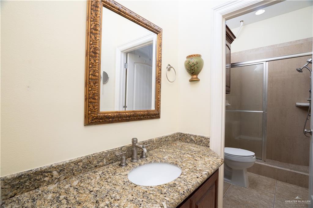508 El Paisano Road Rio Grande City, TX 78582 - Photo 36 of 40 a bathroom with a granite countertop sink toilet and shower