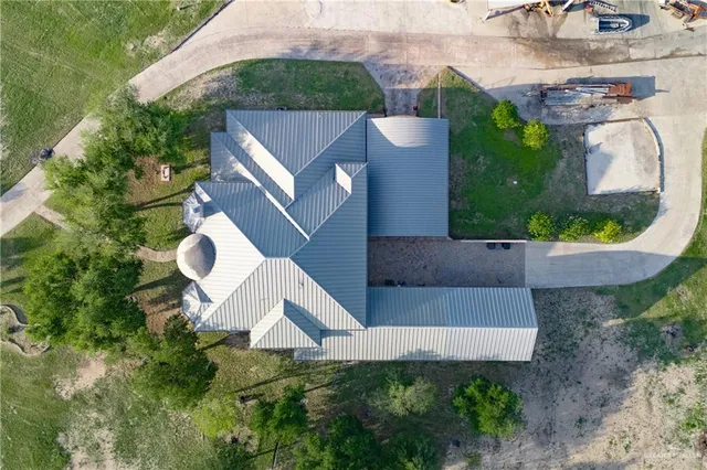 a aerial view of a house with a yard and plants