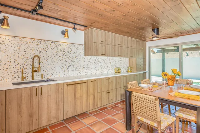 a kitchen with stainless steel appliances a sink and cabinets