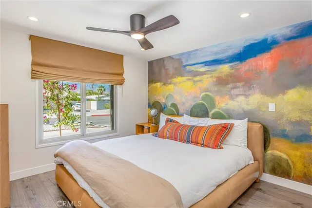 a bedroom with a bed and a large window