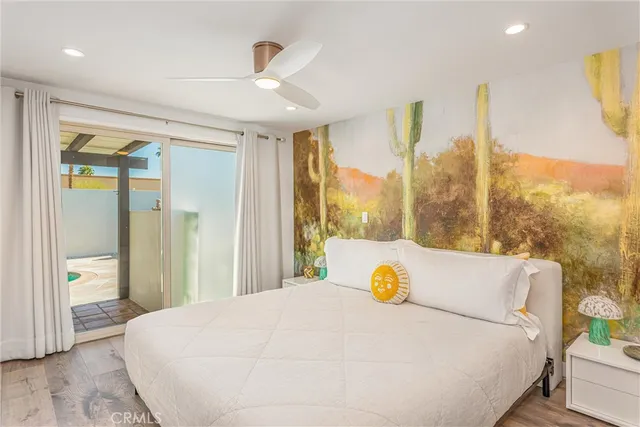 a bedroom with a large bed and a chandelier