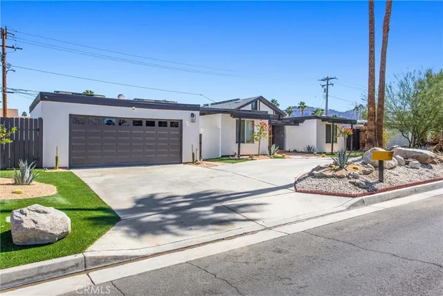 a view of a house with a yard and garage