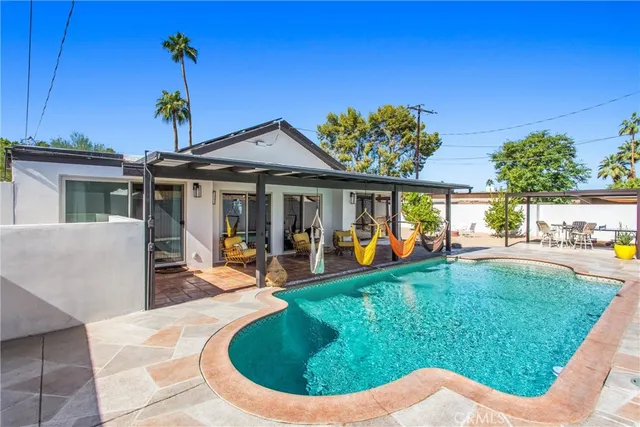 a view of a house with backyard porch and sitting area