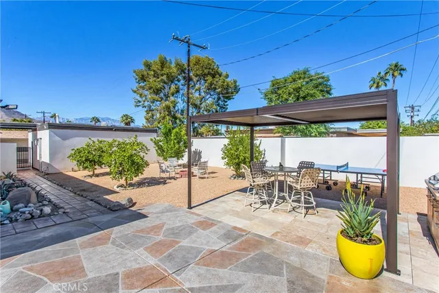 a view of a patio with table and chairs potted plants with wooden floor