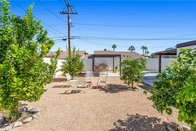 a view of a patio with table and chairs potted plants