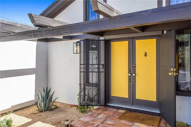a view of porch with a table and chairs