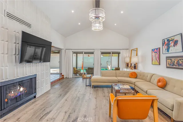 a living room with fireplace furniture and a flat screen tv