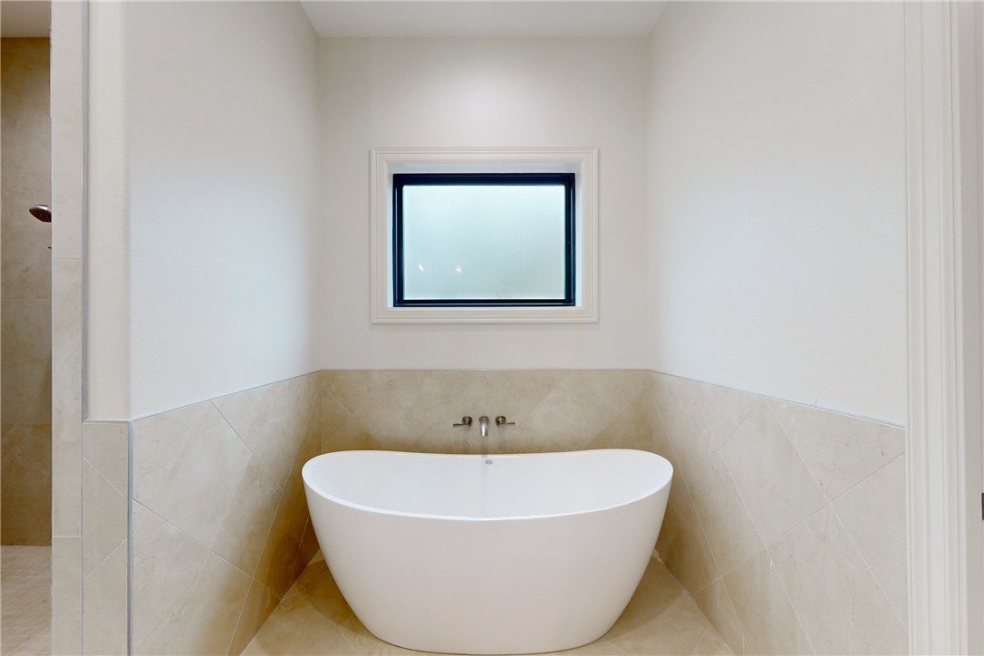3317 Legacy Court Bryan, TX 77802 - Photo 12 of 28 a white bath tub sitting in a bathroom