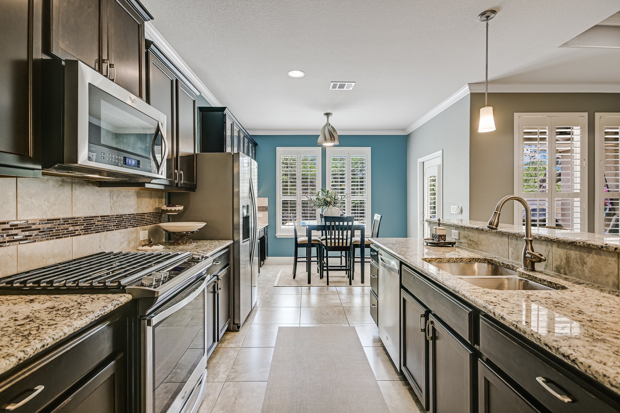 304 Coffee Mill Creek Road Georgetown, TX 78633 - Photo 12 of 30 Kitchen featuring stainless steel appliances, granite counters, decorative backsplash and pendant lighting