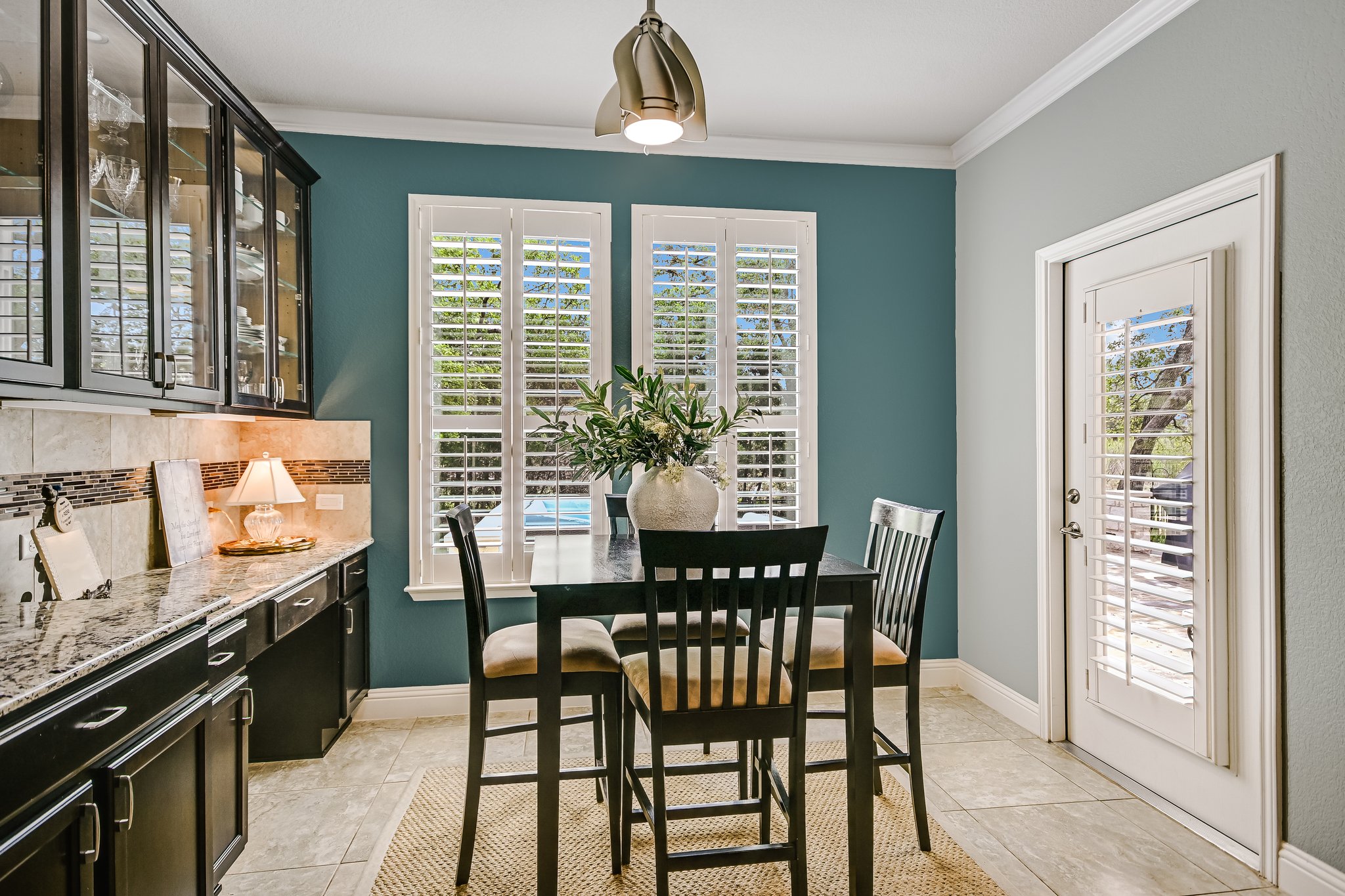 304 Coffee Mill Creek Road Georgetown, TX 78633 - Photo 13 of 30 Breakfast dining opens to the covered patio. Glass front cabinetry highlights your collections and a desk area is a wonderful work space for getting organized