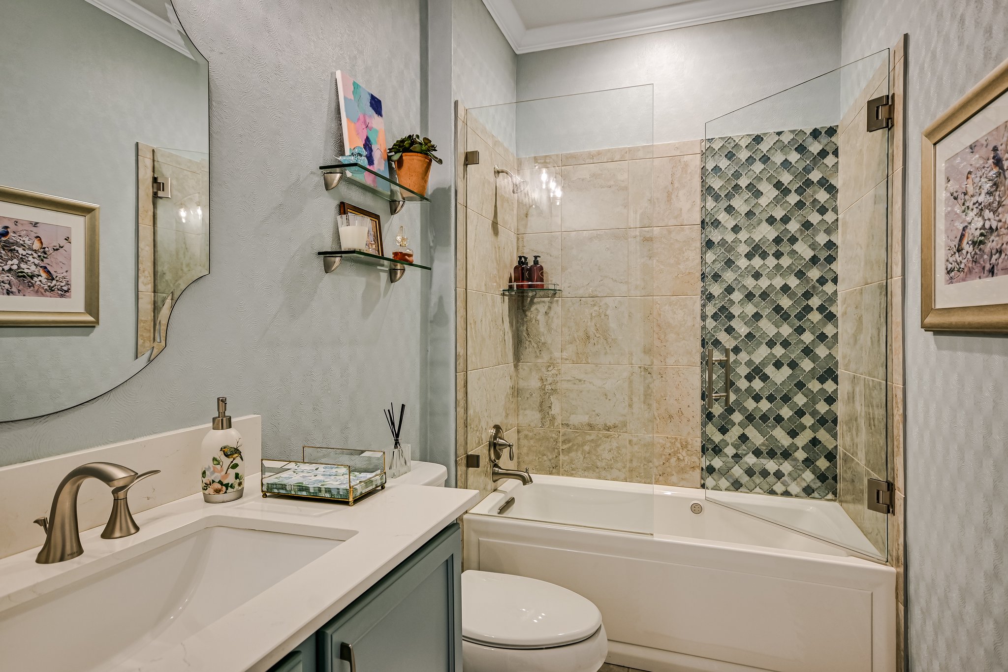 304 Coffee Mill Creek Road Georgetown, TX 78633 - Photo 17 of 30 Guest bath has been updated and features air tub with glass doors, decorative shower tiles, quartz counter top, lighting, mirror, new sink, painted cabinetry