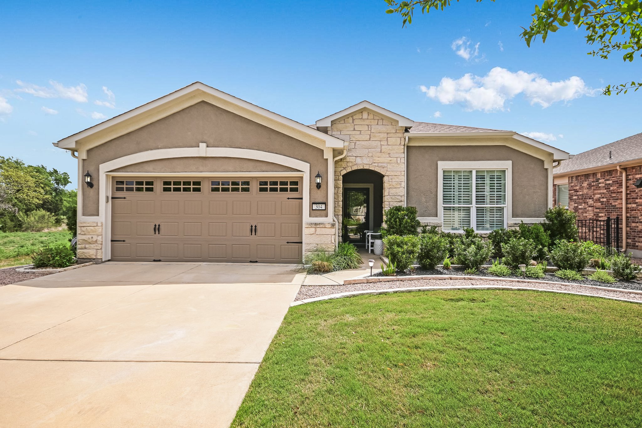 304 Coffee Mill Creek Road Georgetown, TX 78633 - Photo 2 of 30 Covered entry with 2 car garage, painted with ceiling fan and storage racks