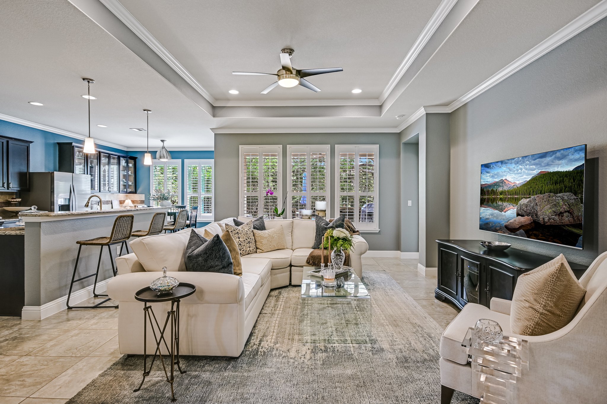 304 Coffee Mill Creek Road Georgetown, TX 78633 - Photo 8 of 30 Living area has crown molding, tray ceiling, recessed lighting, ceiling fan, and light gray tile floors