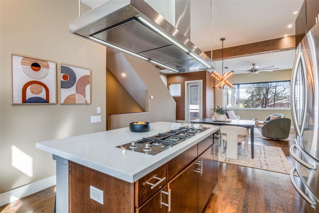 4610 Steel Street Dallas, TX 75219 - Photo 11 of 18 a kitchen with a stove cabinets and wooden floor