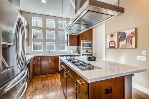 a kitchen with stainless steel appliances granite countertop a stove and a refrigerator
