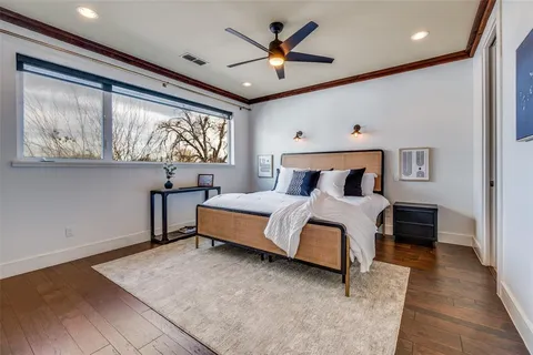 a bedroom with a large bed and a chandelier