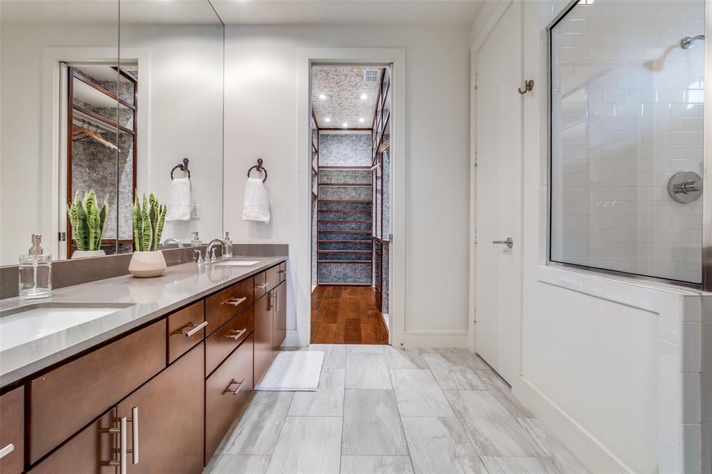 4610 Steel Street Dallas, TX 75219 - Photo 15 of 18 a spacious bathroom with a granite countertop sink a toilet a mirror and shower