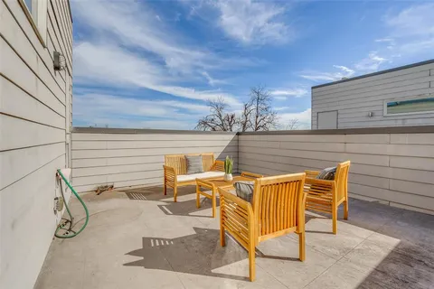 a view of an outdoor sitting area with brick walls