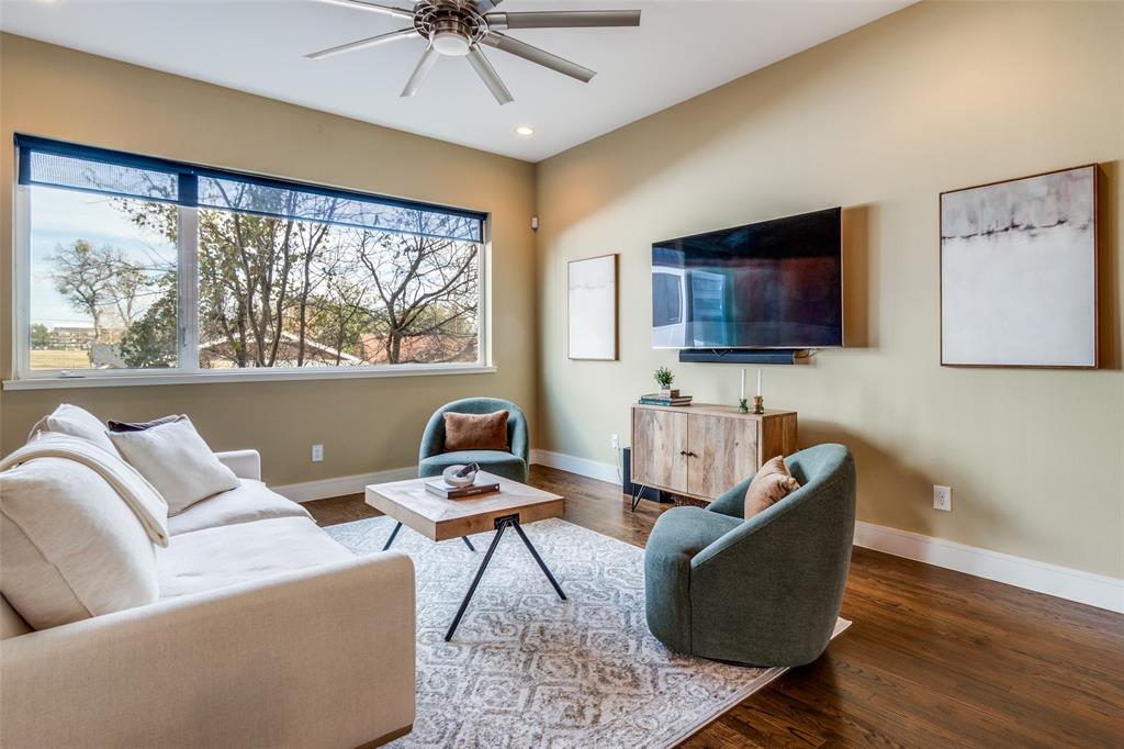 4610 Steel Street Dallas, TX 75219 - Photo 8 of 18 a living room with furniture a flat screen tv and a large window