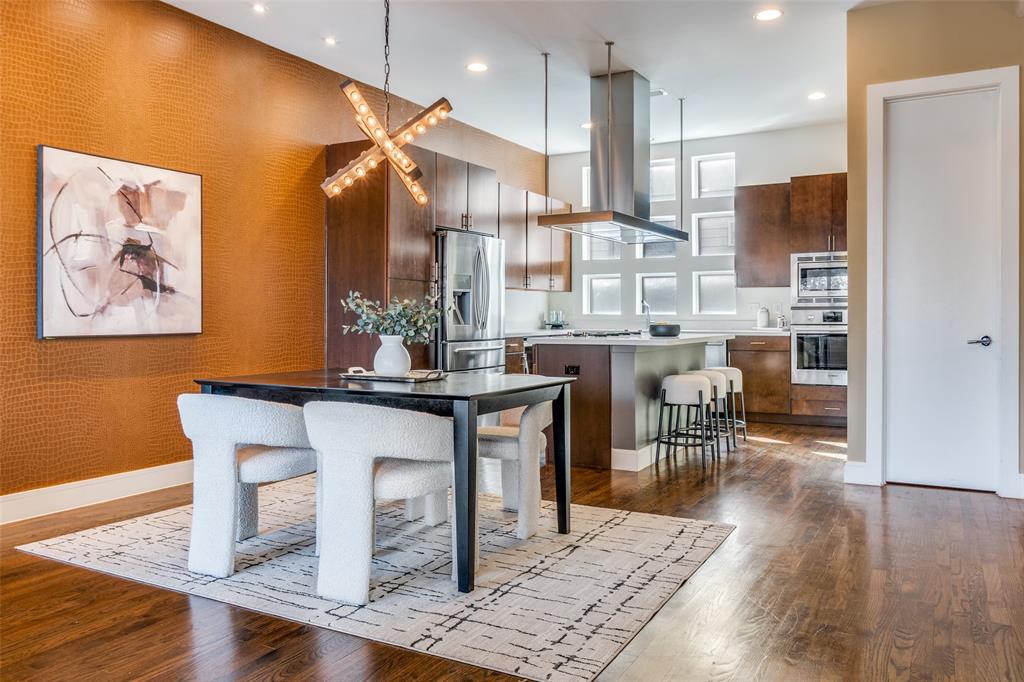 4610 Steel Street Dallas, TX 75219 - Photo 10 of 18 a room with stainless steel appliances kitchen island granite countertop furniture and a wooden floor