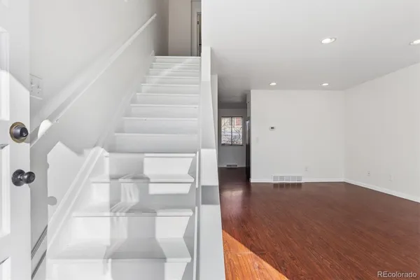a view of entryway and hall with wooden floor