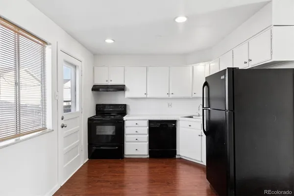 a kitchen with a refrigerator and a stove