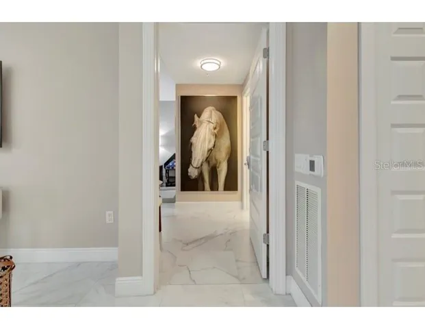 a view of a hallway and a livingroom with furniture