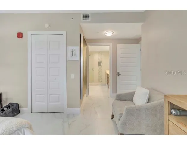 a living room with furniture and a wooden door