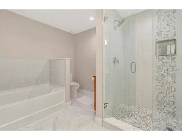 a bathroom with a bathtub and a shower