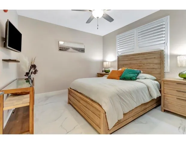 a bedroom with a bed and a flat screen tv